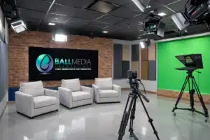 Corporate video production studio with green screen and interview seating