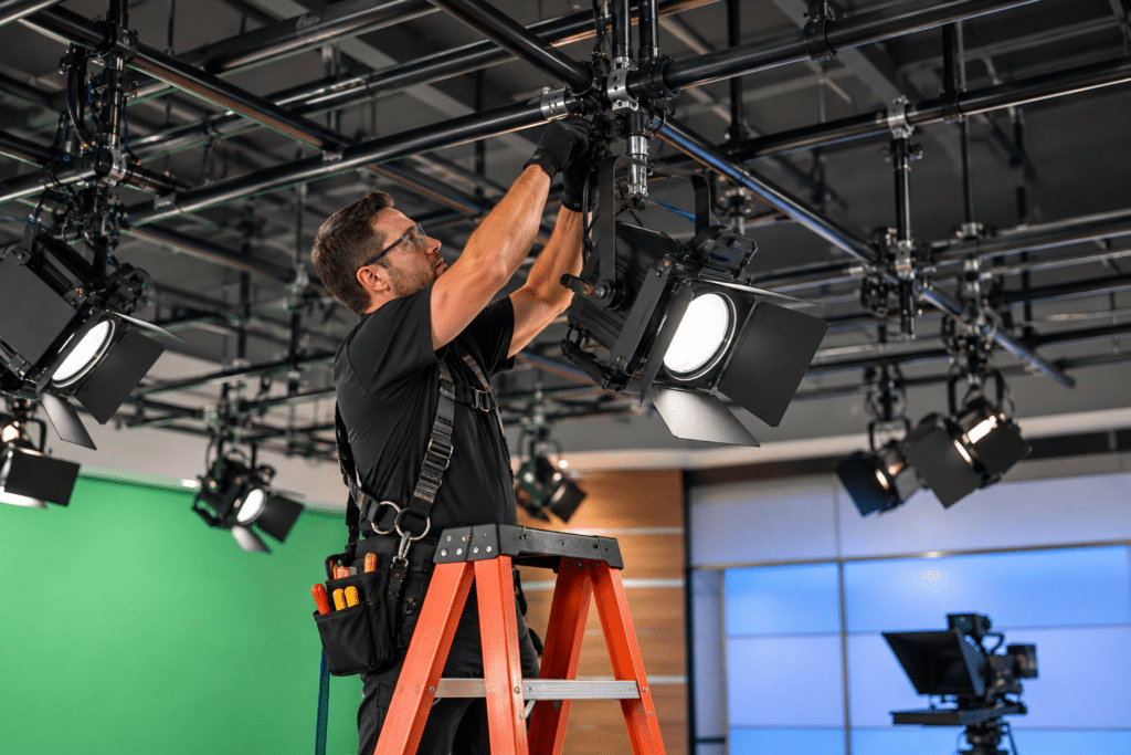 Technician installing a lighting grid in a new professional TV studio
